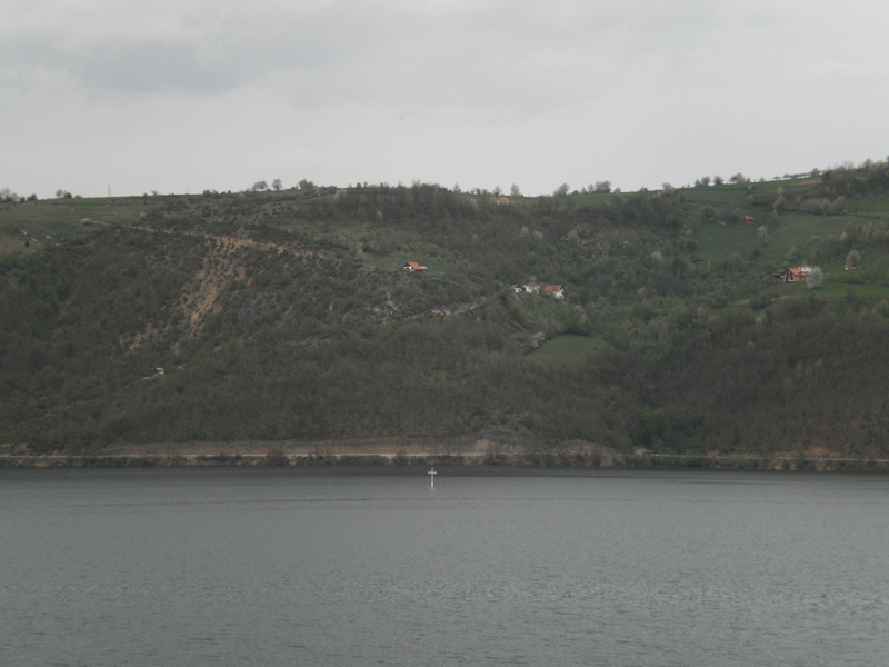 The top of the church appears in the lake